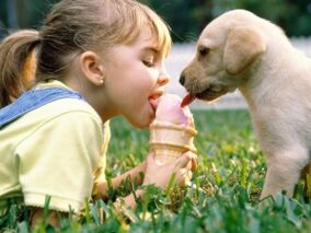 a girl eats ice cream with a dog and gets parasites